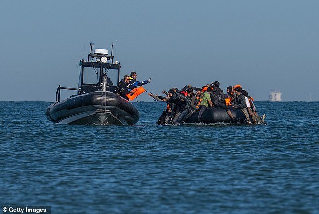 101583879-15038353-A_French_police_vessel_passes_lifejackets_to_people_on_a_dinghy_-a-3_1756281897056.jpg