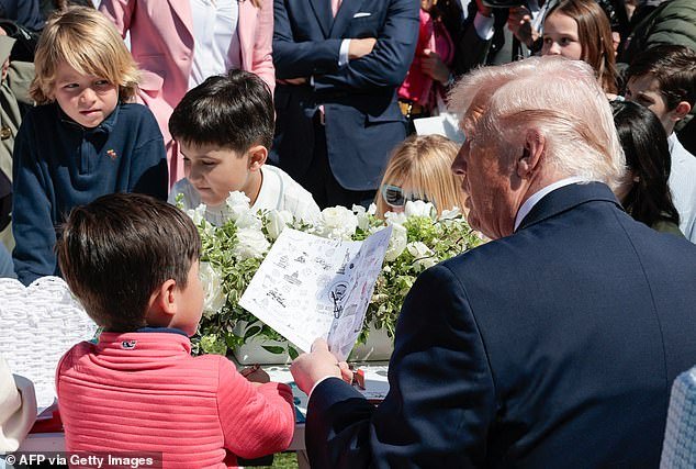 107691989-15710339-President_Donald_Trump_is_photographed_as_he_tells_a_little_boy_-a-50_1775503002967.jpg